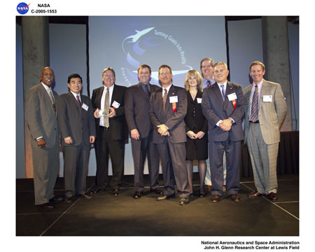 VMOC award winners on stage with Michael Griffin. From left: Julian Earls (Director, NASA Glenn), Jaiwon Shin, NASA Deputy Associate Administrator for Aeronautics, Phil Paulsen (NASA Glenn), Eric Miller (General Dynamics Advanced Information Systems), Jay Heberle (Universal Space Network), Lisa Porter (NASA Associate Administrator for Aeronautics), Dan Shell (Cisco Systems), Phil Ardire (Western Datacom), Mike Griffin (NASA Administrator).